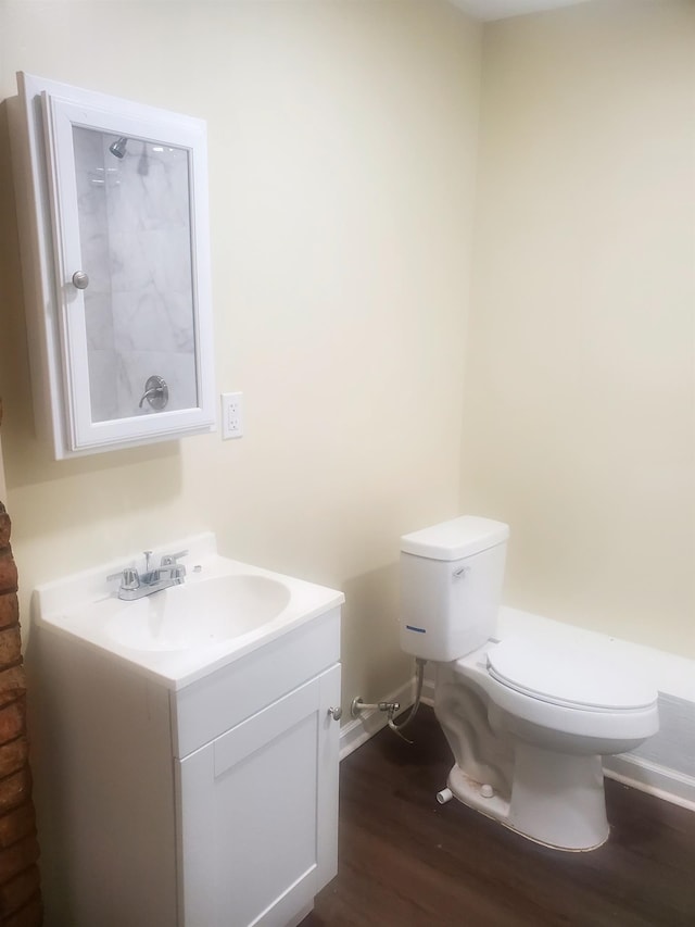 bathroom with hardwood / wood-style flooring, vanity, and toilet