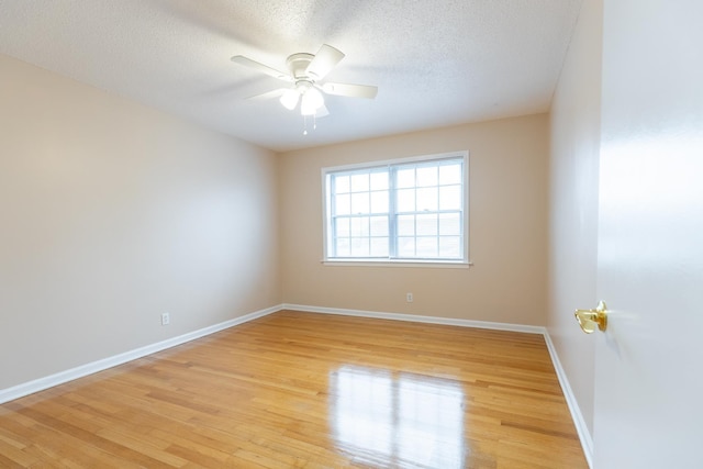 unfurnished room with ceiling fan, light hardwood / wood-style flooring, and a textured ceiling