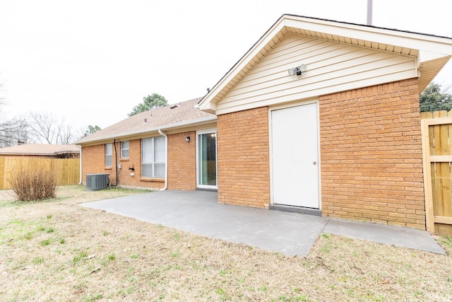 rear view of house featuring cooling unit and a patio area