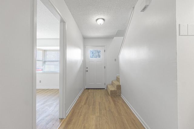 entryway featuring a textured ceiling and light wood-type flooring