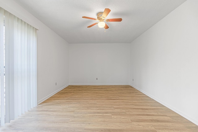 spare room featuring ceiling fan, light hardwood / wood-style flooring, and a textured ceiling