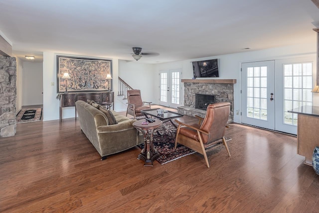 living room featuring dark hardwood / wood-style flooring, a fireplace, and french doors