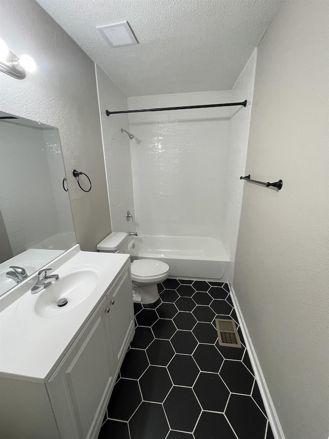 full bathroom featuring vanity, a textured ceiling, shower / bathtub combination, and toilet