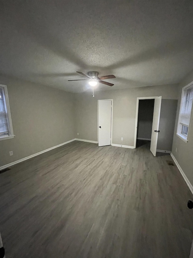 unfurnished bedroom with ceiling fan, hardwood / wood-style floors, and a textured ceiling