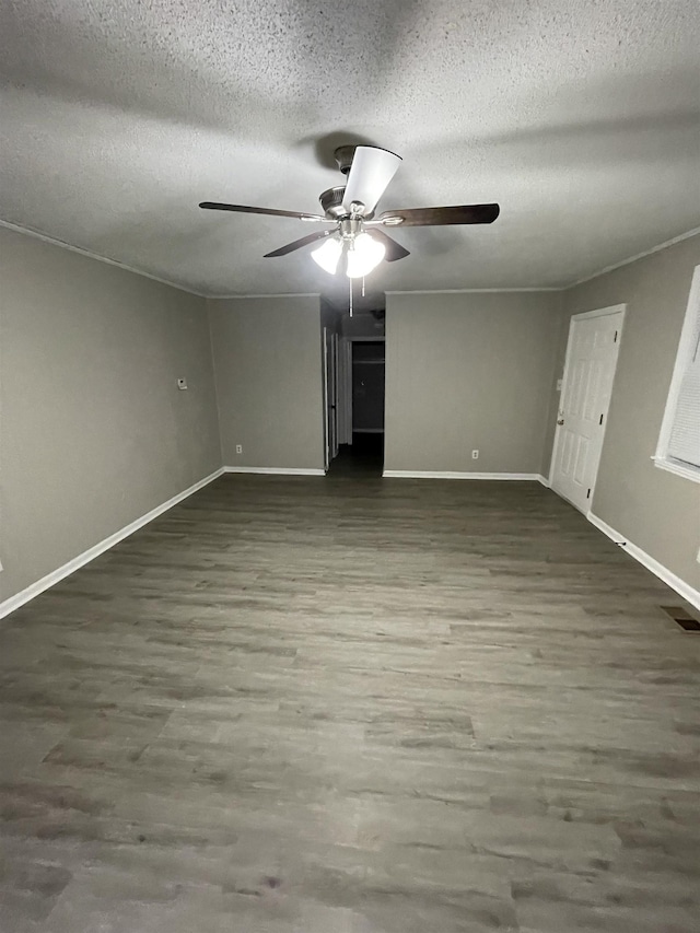 unfurnished bedroom with dark hardwood / wood-style flooring, ceiling fan, and a textured ceiling