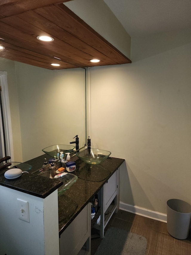 bathroom featuring wood ceiling and vanity