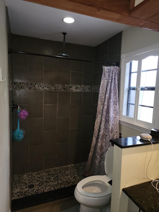 bathroom featuring curtained shower and toilet