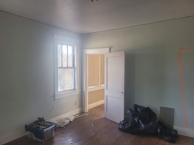 spare room featuring dark hardwood / wood-style flooring