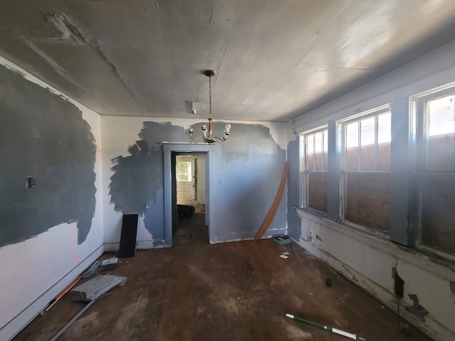 unfurnished dining area with a notable chandelier