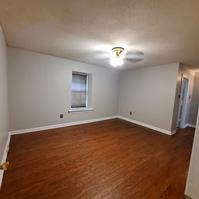 spare room featuring dark hardwood / wood-style flooring, a textured ceiling, and ceiling fan