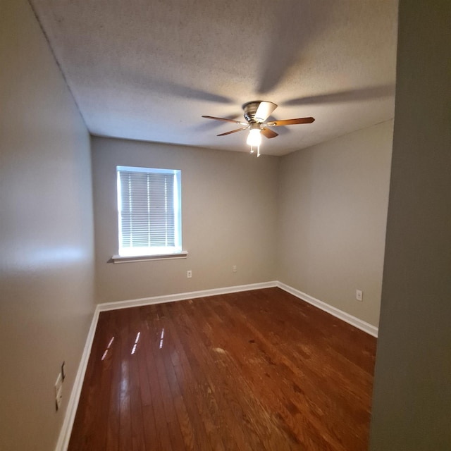 unfurnished room with ceiling fan, a textured ceiling, and dark hardwood / wood-style flooring