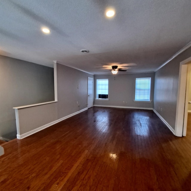 spare room with a textured ceiling, ornamental molding, dark hardwood / wood-style floors, and ceiling fan