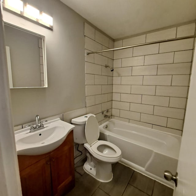 full bathroom featuring vanity, toilet, and tiled shower / bath