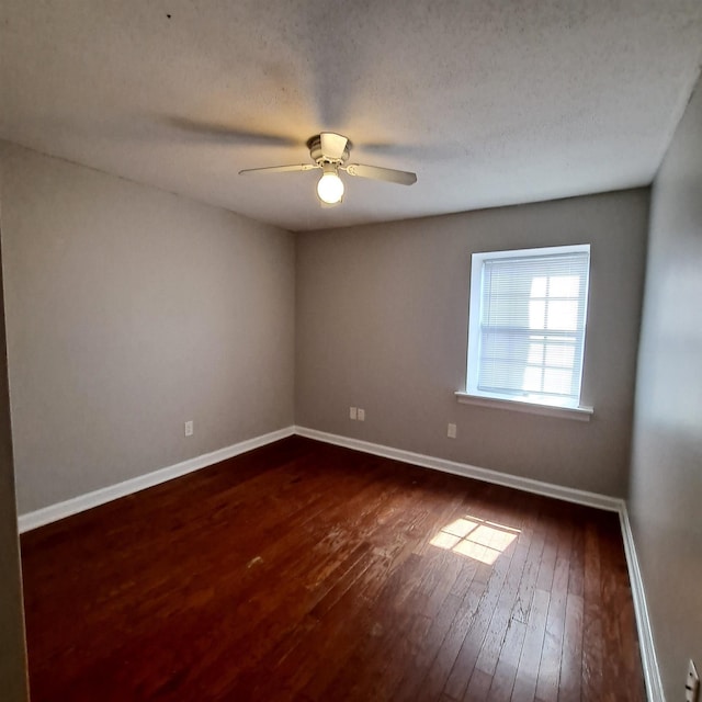 spare room featuring ceiling fan, dark hardwood / wood-style floors, and a textured ceiling