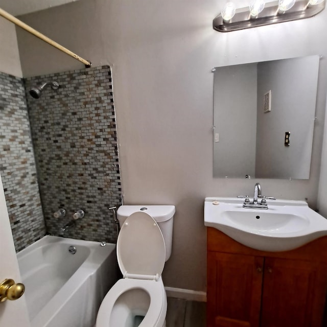 full bathroom with vanity, toilet, and tiled shower / bath combo