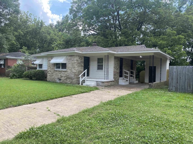 view of front facade with a carport and a front yard