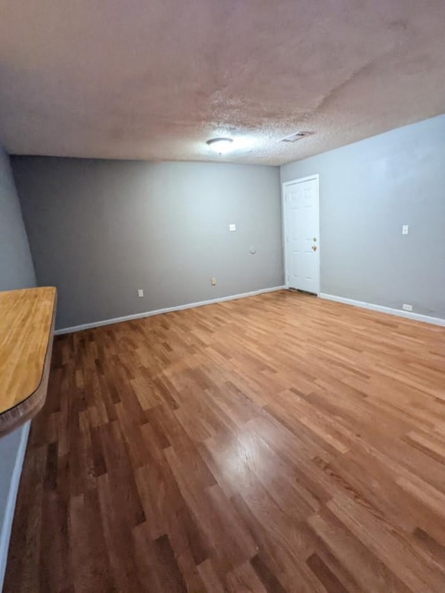 interior space featuring hardwood / wood-style floors and a textured ceiling