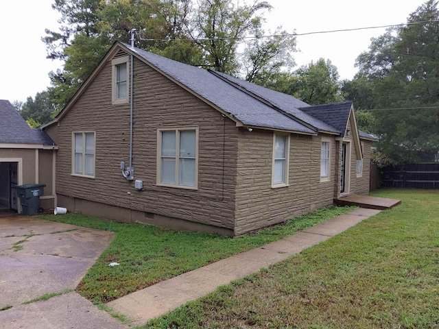 view of home's exterior with a yard