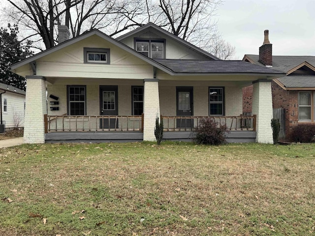 bungalow-style house with a porch and a front yard