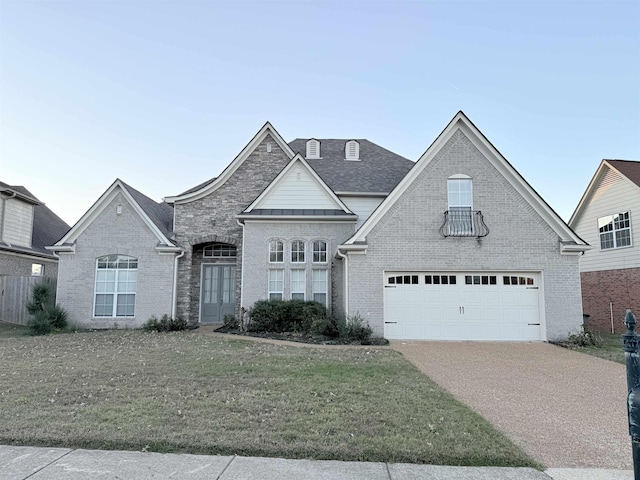 view of front of house featuring a garage and a front lawn