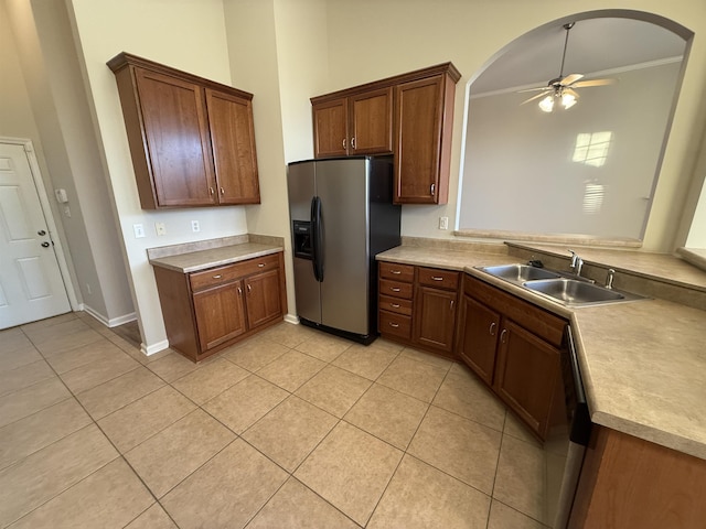 kitchen with dishwashing machine, light tile patterned floors, sink, stainless steel fridge, and ceiling fan