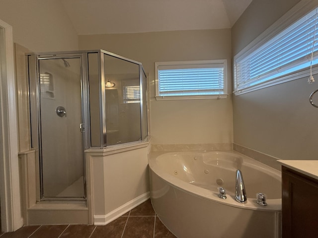 bathroom with independent shower and bath, vanity, and tile patterned floors