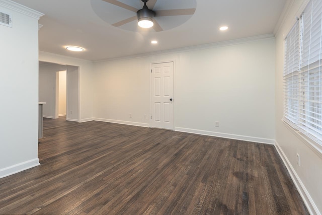 empty room featuring ornamental molding, dark wood-type flooring, and ceiling fan