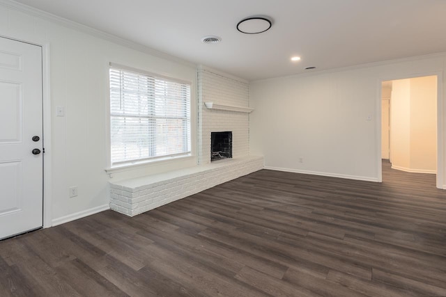 unfurnished living room featuring crown molding, a fireplace, and dark wood-type flooring