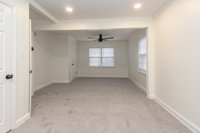 unfurnished room with crown molding, light colored carpet, and ceiling fan