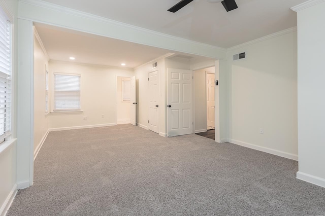 unfurnished room with crown molding, carpet floors, and ceiling fan