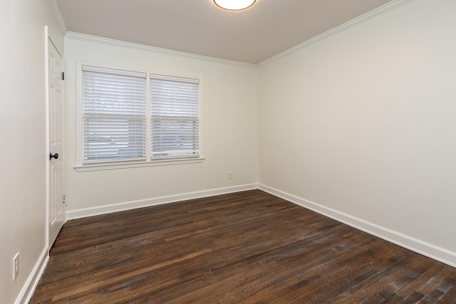 empty room featuring dark hardwood / wood-style flooring and ornamental molding