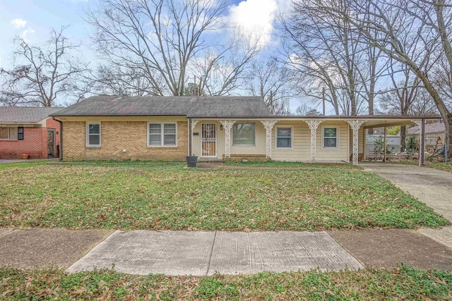 ranch-style home featuring a carport and a front lawn