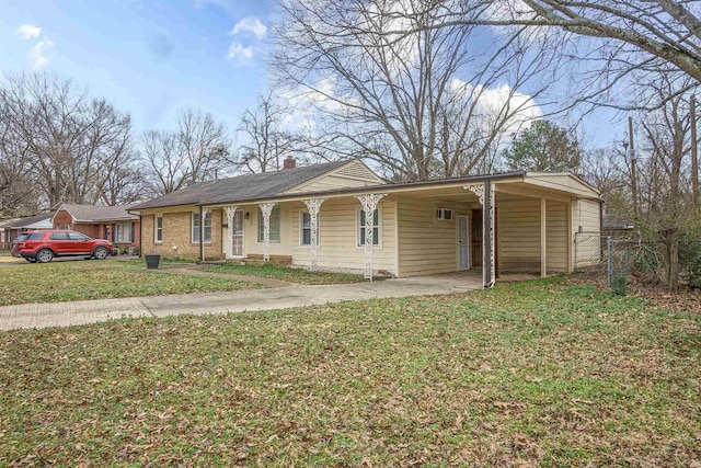 ranch-style home featuring a carport and a front lawn