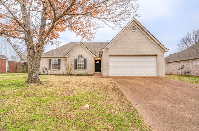 ranch-style home with a garage and a front lawn