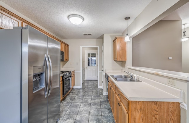 kitchen featuring black appliances, sink, hanging light fixtures, kitchen peninsula, and a textured ceiling