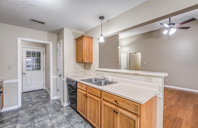 kitchen featuring sink, hanging light fixtures, a textured ceiling, kitchen peninsula, and dishwasher