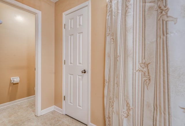 hall with light tile patterned flooring