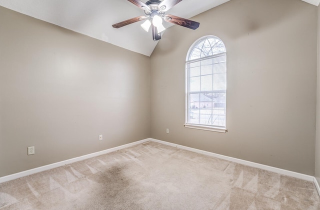 carpeted empty room with ceiling fan and lofted ceiling