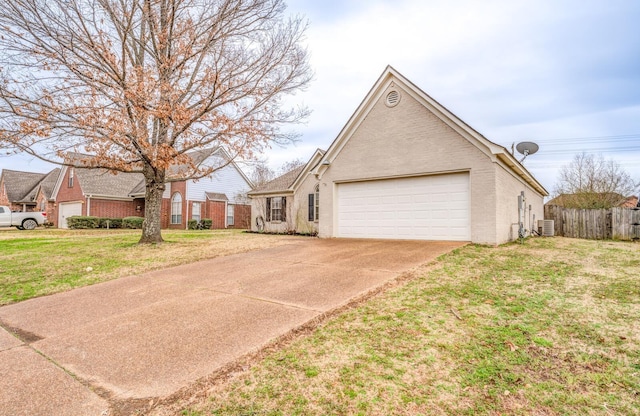 view of front of home featuring a garage, a front yard, and central air condition unit