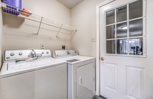 washroom with washing machine and clothes dryer