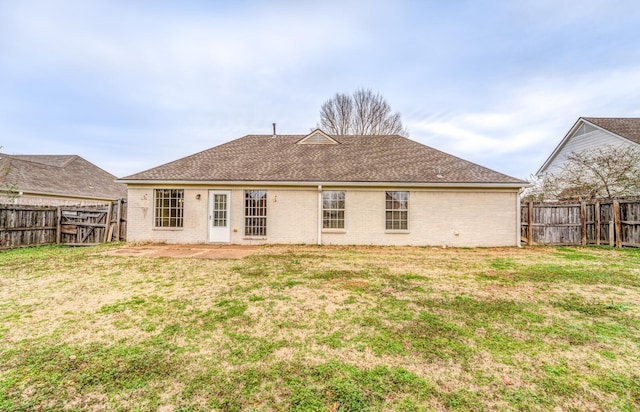 back of property featuring a lawn