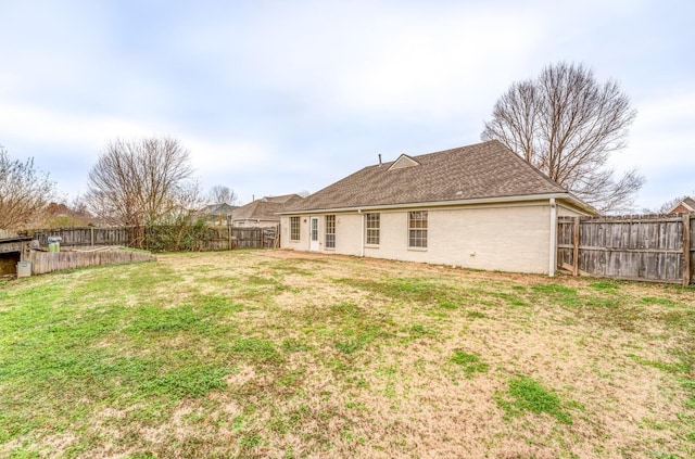 rear view of property with a lawn