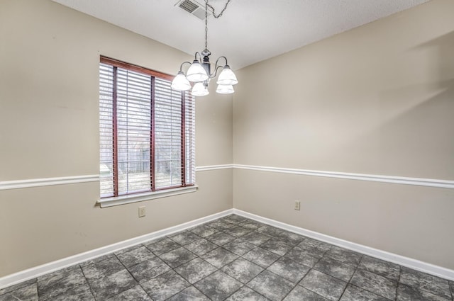 empty room featuring a notable chandelier