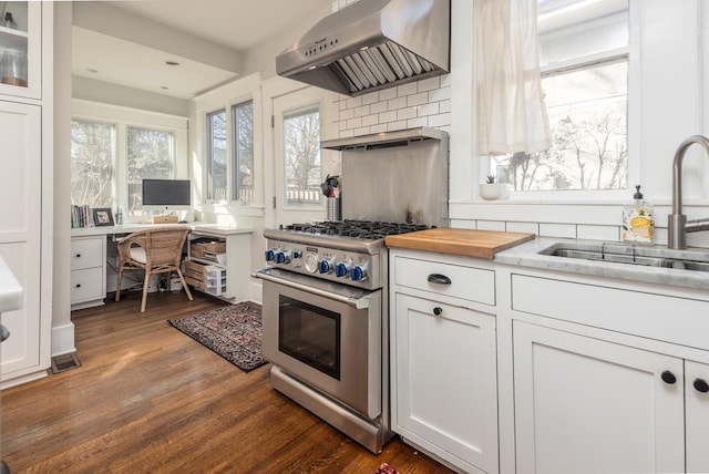 kitchen with white cabinetry, sink, dark hardwood / wood-style flooring, high end stainless steel range, and wall chimney exhaust hood