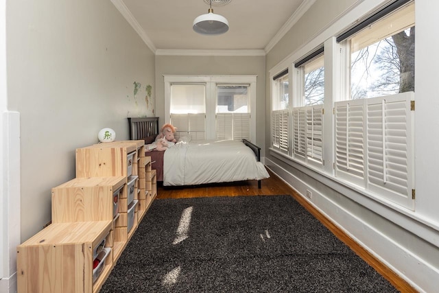 bedroom with crown molding and dark hardwood / wood-style floors