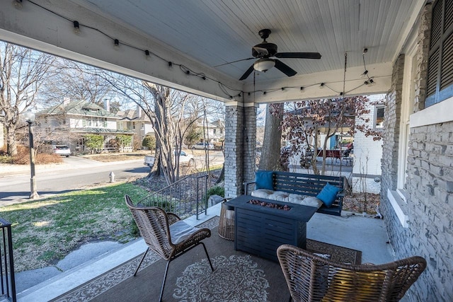 view of patio / terrace with a fire pit and ceiling fan