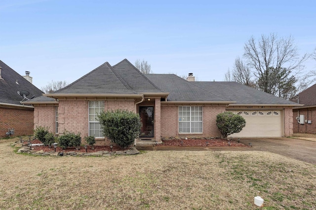 ranch-style home with a garage and a front lawn