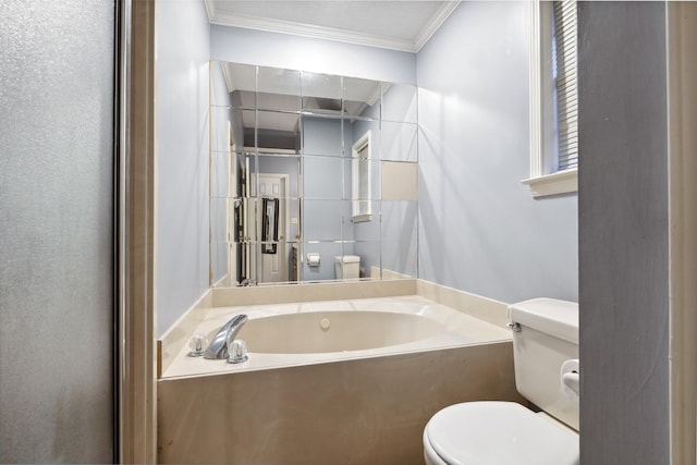 bathroom with ornamental molding, a bath, and toilet