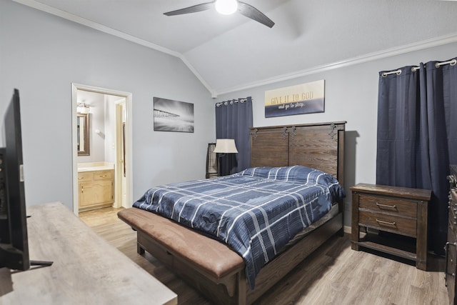 bedroom with vaulted ceiling, ensuite bathroom, ornamental molding, ceiling fan, and light hardwood / wood-style floors