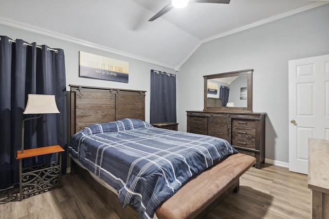 bedroom with crown molding, ceiling fan, lofted ceiling, and hardwood / wood-style floors